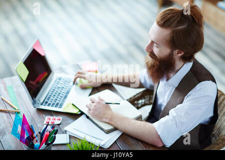 Young web-designer searching for data in the net Stock Photo