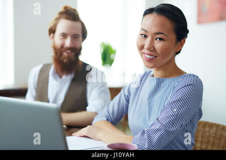 Team of creative designers sitting by workplace in studio Stock Photo