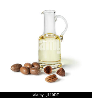 Glass can with pecan oil on white background Stock Photo