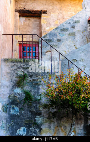 Stone wall and window, gardens, courtyard at Carmel Mission, Carmel by the Sea, California, USA. Stock Photo