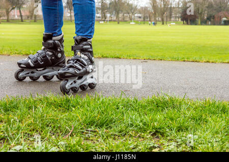 Womans legs on roller skating in park Stock Photo