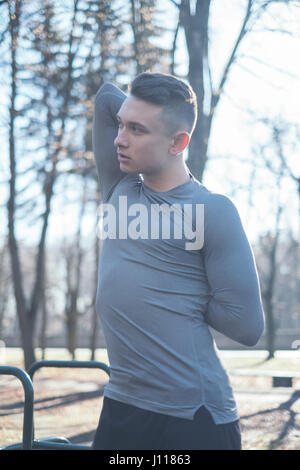 Man standing in the park stretching, Minsk, Belarus Stock Photo