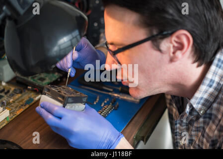 Technician looking at computer components Stock Photo