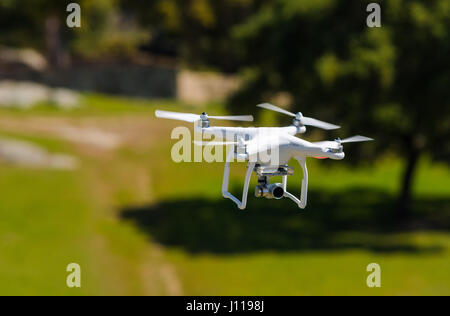 flying drone armed with camera Stock Photo
