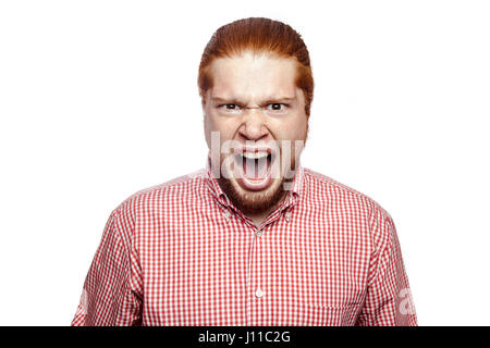 Screaming angry bearded readhead businessman with red shirt and freckles looking at camera. studio shot isolated on white. Stock Photo