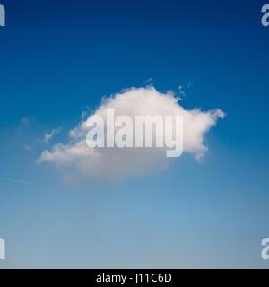 Small white cloud floating against blue sky Stock Photo