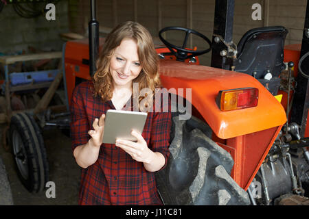 Female Agricultural Worker On Farm Using Digital Tablet Stock Photo