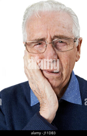 Studio Portrait Of Senior Man Suffering With Toothache Stock Photo