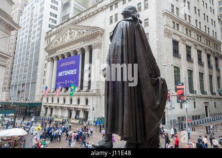 The statue of George Washington in front of Federal Hall watches the New York Stock Exchange decorated for the initial public offering of Netshoes on Wednesday, April 12, 2017. Netshoes (Cayman) Ltd. sells sports and lifestyle products online in Latin America. (© Richard B. Levine) Stock Photo