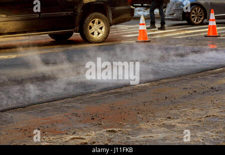Urban road is under construction, asphalting in progress, fragment of yellow roller Stock Photo