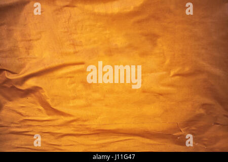 Golden yellow glued poster paper background, creased and crumpled surface Stock Photo