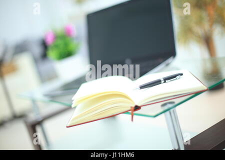 Pencil and notebook on laptop for business concept. Stock Photo