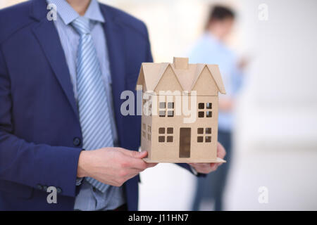 Two colleagues discussing data working and tablet, laptop with on on architectural project at construction site at desk in office Stock Photo