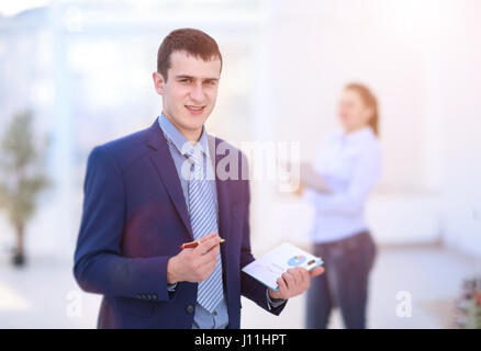 Two colleagues discussing data working and tablet, laptop with on on architectural project at construction site at desk in office Stock Photo