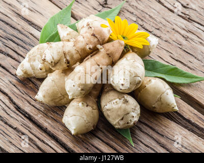 Jerusalem artichoke on wooden table. Stock Photo