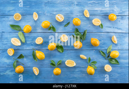 Ripe lemons and oranges on the white wooden table. Top view. Stock Photo