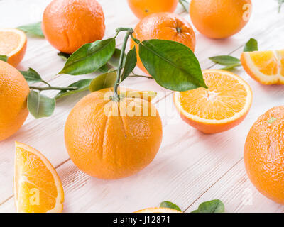 Ripe oranges on the white wooden table. Stock Photo