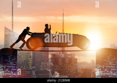 Teamwork concept with businessman pushing car Stock Photo