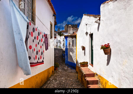 'Anscestral linen': A neighborhoud street in the medieval town of Obidos Stock Photo