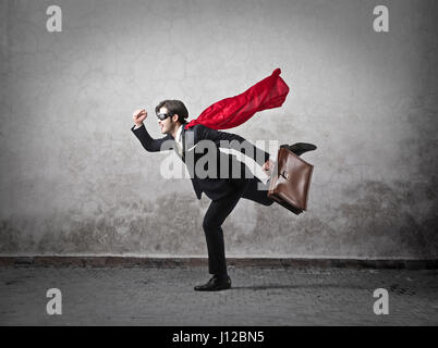 Businessman with cape running with briefcase Stock Photo