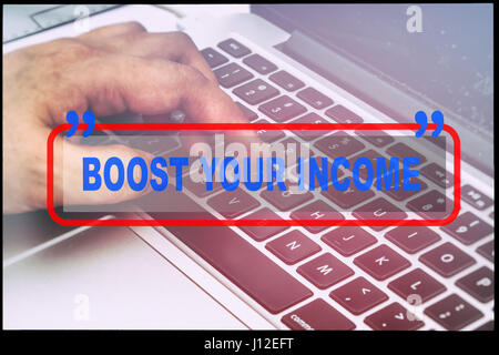 Hand and text  "BOOST YOUR INCOME" with vintage background. Technology concept. Stock Photo