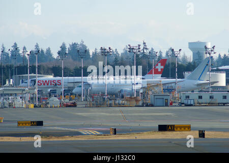 EVERETT, WASHINGTON, USA - JAN 26th, 2017: Boeing production site, the huge factory at Snohomish County Airport or Paine Field, a brand new SWISS B777 and a B787 Dreamliner in the background