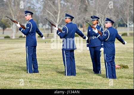 Senior Airman Joseph Trujillo of the 163d Force Support Squadron (right) performs a 3-volley rifle salute with the Blue Eagles Honor Guard firing party while rendering funeral honors for a retiree Jan. 14, 2016, at Riverside National Cemetery in Riverside, California. Serving on the honor guard gives Trujillo a way to connect with his grandfather, a Navy veteran who is buried at the same cemetery. (Air National Guard Photo by Airman 1st Class Crystal Chatham Housman)(Released) Stock Photo