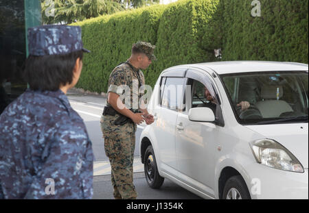 U.S. Marines with the Provost Marshal’s Office and Japanese sentries conduct random car searches during anti-terrorism training at Marine Corps Air Station Iwakuni, Japan, March 27, 2017. The Marines and Japanese worked together and checked for anything that could be considered a threat to the air station. (U.S. Marine Corps photo by Lance Cpl. Jacob A. Farbo) Stock Photo