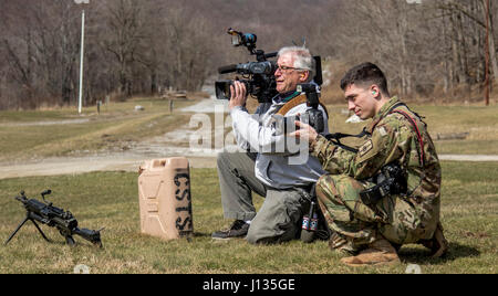 U.S. Army Sgt. Harley Jelis, a public affairs specialist attached to the 138th Public Affairs Detachment, 53rd Troop Command, New York Army National Guard, and winner of the U.S. Army Keith L. Ware Military Photographer of the Year award, shoots photos and video during the 2017 Mew York Army National Guard Best Warrior Competition at Camp Smith Training Site March 30, 2017. (U.S. Army National Guard photo by Staff Sgt. Michael Davis) Stock Photo