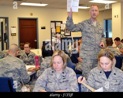 A Senior Master Sergeant conducts Four Lenses training at the 111th Medical Group to teach Airmen temperament self-assessment and improve professional and interpersonal interactions within work groups. Stock Photo