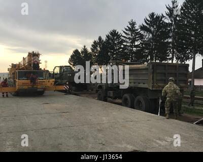 VOILA, Romania -- Soldiers of the South Carolina Army National Guard, 122nd Engineer Battalion, 59th troop command, the United States Army Reserves, 702nd Horizontal Engineer Company, 844th Engineer Battalion, 926th Engineer Brigade, and the Romanian Land Forces operated in conjunction to offload 196 vehicles and pieces of equipment from April 1 to April 4, 2017. Stock Photo