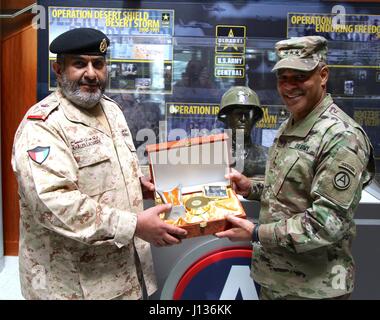 Lt. Gen. Michael Garrett, U.S. Army Central, commanding general, receives a gift from Maj. Gen. Khaled Saleh Al-Sabah, the Kuwait land forces commander dur-ing his visit to USARCENT headquarters at Shaw Air Force Base, S.C., April 5, 2017. During the visit USACRENT and key personnel met and discussed multi-ple topics to help build the long partnership between the two countries (U.S. Ar-my photo by Staff Sgt. Jared Crain) Stock Photo