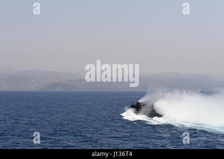 170405-N-ME988-294 U.S. 5TH FLEET AREA OF OPERATIONS (April 5, 2017) Landing Craft Air Cushion 2, assigned to Assault Craft Unit 4 (ACU 4), departs the well deck onboard the amphibious dock landing ship USS Carter Hall (LSD 50) to take vehicle and equipment to the beach for exercise Alligator Dagger 17 in the vicinity of Djibouti. The U.S. 5th Fleet-led exercise provides an opportunity to enhance multilateral capabilities in critical mission sets inherent to the U.S. Navy-Marine Corps, as well as partners and allies in the region.  (U.S. Navy photo by Mass Communication Specialist 1st Class Da Stock Photo