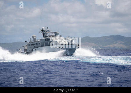 A MK VI patrol boat, assigned to Coastal Riverine Group (CRG) 1 Detachment Guam, maneuvers off the coast of Guam April 6, 2017. CRG 1 Detachment Guam is assigned to Commander, Task Force 75, which is the primary expeditionary task force responsible for the planning and execution of coastal riverine operations, explosive ordnance disposal, mobile diving and salvage, engineering and construction, and underwater construction in the U.S. 7th Fleet area of operations. (U.S. Navy Combat Camera photo by Mass Communication Specialist 3rd Class Alfred A. Coffield) Stock Photo