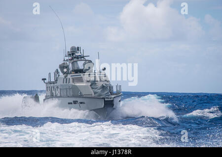 A MK VI patrol boat, assigned to Coastal Riverine Group (CRG) 1 Detachment Guam, maneuvers off the coast of Guam April 6, 2017. CRG 1 Detachment Guam is assigned to Commander, Task Force 75, which is the primary expeditionary task force responsible for the planning and execution of coastal riverine operations, explosive ordnance disposal, mobile diving and salvage, engineering and construction, and underwater construction in the U.S. 7th Fleet area of operations. (U.S. Navy Combat Camera photo by Mass Communication Specialist 3rd Class Alfred A. Coffield) Stock Photo