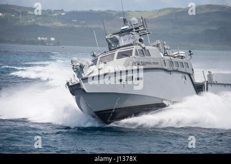 A MK VI patrol boat, assigned to Coastal Riverine Group (CRG) 1 Detachment Guam, maneuvers off the coast of Guam April 6, 2017. CRG 1 Detachment Guam is assigned to Commander, Task Force 75, which is the primary expeditionary task force responsible for the planning and execution of coastal riverine operations, explosive ordnance disposal, mobile diving and salvage, engineering and construction, and underwater construction in the U.S. 7th Fleet area of operations. (U.S. Navy Combat Camera photo by Mass Communication Specialist 3rd Class Alfred A. Coffield) Stock Photo