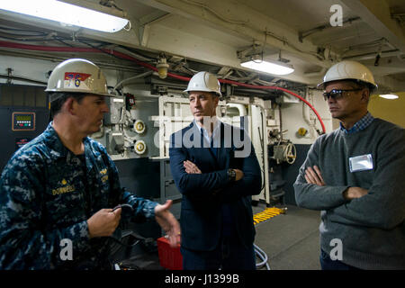 170410-N-AF125-325 YOKOSUKA, Japan (April 10, 2017) Capt. Buzz Donnelly, commanding officer of the Navy’s only forward-deployed aircraft carrier, USS Ronald Reagan (CVN 76), speaks to Sen. Patrick Maloney, New York, center, and his spouse, Randy Florke, during a tour of the ship. Ronald Reagan, the flagship of Carrier Strike Group 5, provides a combat-ready force that protects and defends the collective maritime interests of its allies and partners in the Indo-Asia-Pacific region. (U.S. Navy photo by Mass Communication Specialist Seaman Frank Joseph Speciale/Released) Stock Photo