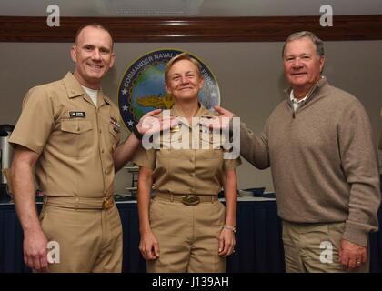 170410-N-JO908-042 SAN DIEGO (April. 10, 2017) Vice Adm. Nora W. Tyson, commander, U.S. 3rd Fleet, poses with Master Chief Petty Officer of the Navy (MCPON) Steven Giordano, left, and her husband, after being pinned as an honorary chief petty officer during a ceremony, April 10. (U.S. Navy photo by Mass Communication Specialist 2nd Class Kory Alsberry/Released) Stock Photo