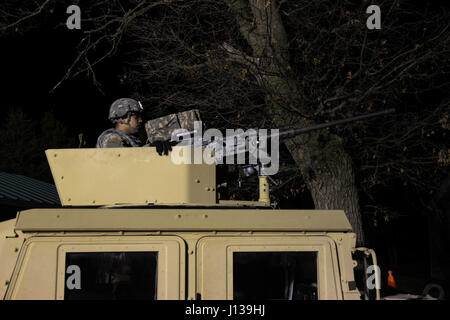 A U.S. Army Reserve Soldier with 325th Psychological Operations Company (Airborne), U.S. Army Civil Affairs and Psychological Operation Command, prepares for basic night live-fire during Operation Cold Steel at Fort McCoy, Wis., April 11, 2017. Operation Cold Steel is the U.S. Army Reserve's crew-served weapons qualification and validation exercise to ensure that America's Army Reserve units and Soldiers are trained and ready to deploy on short-notice and bring combat-ready and lethal firepower in support of the Army and our joint partners anywhere in the world. (U.S. Army Reserve photo by Sta Stock Photo