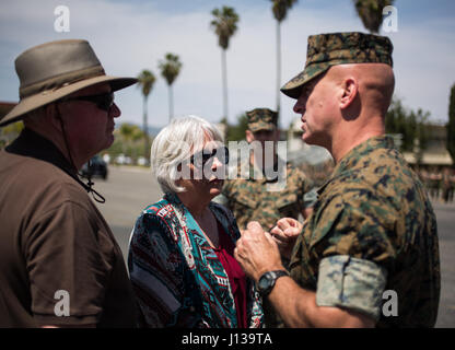 U.S Marine Brig. Gen. David Ottignon thanks Nina and Gary Walker, advocates for Mothers Against Drunk Driving (MADD), for sharing their story with the Marines during the 101 Days of Summer Resource Fair within 1st Marine Logistics Group on Marine Corps Base Camp Pendleton, Calif., April 11, 2017. The fair is an event that gives Marines the resources necessary to mentor their fellow Marines. Ottignon is the commanding general for 1st Marine Logistics Group. (U.S. Marine Corps Photo by Lance Cpl. Timothy Shoemaker/Released) Stock Photo