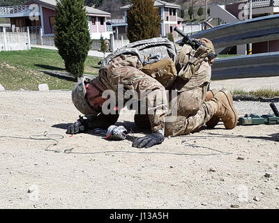 A Staff Sergeant from the 23rd CBRNE Battalion, 210th Field Artillery Brigade, 2nd Infantry Division inspects a simulated IED during joint EOD training at Rodriguez Live Fire Complex, Korea, April 12, 2017. Six two-man teams competed to determine the best EOD team while maintaining operational readiness and skills. Stock Photo