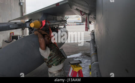 44th Aircraft Maintenance Unit weapons load crew lifts an AIM-9 ...