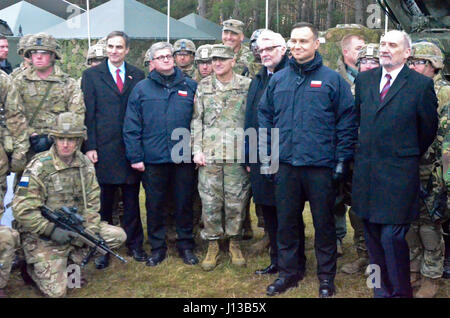 Officials from the U.S. and Poland pose with soldiers of Battle Group Poland following a welcoming ceremony to kick off their deployment, April 13. Battle Group Poland is comprised of soldiers from the United States, United Kingdom, Romania and Poland as part of NATO’s Enhanced Forward Presence. Battle Group Poland is committed to the collective defense and security of NATO Allies and partners in the eastern European region. Shown in photo from left to right: US Ambassador to the Republic of Poland Paul W. Jones; Republic of Poland Secretary of State and Head of the National Security Bureau Pa Stock Photo