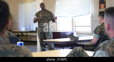 1st Sgt. Korey Wright, Co. 1st Sgt. for H&S Co., H&S Bn., MCI West - MCB Camp Pendleton, addresses Marines attending a social media brief aboard Camp Pendleton April 13, 2017. The brief covers the Marine Corps Policy on Social Media and is conducted to ensure Marines are aware of the policies and regulations. (U.S. Marine Corps Photo by LCpl. Dylan Chagnon) levels adjusted and image cropped to highlight the subject. Stock Photo