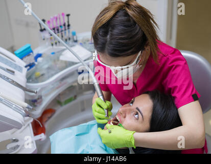 dentist cleaning teeth of woman Stock Photo