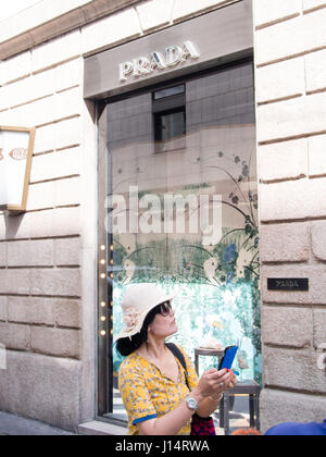 Asian tourist outside Prada 's Shop in Via Montenapoleone , Milano Italy Stock Photo