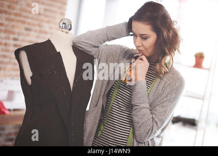 Female fashion designer thinking about changes Stock Photo