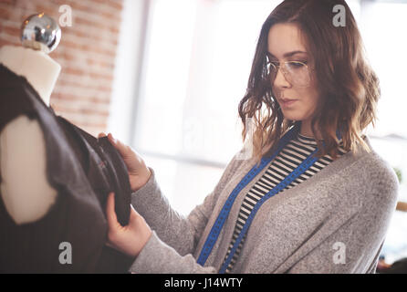 Woman working on tailors dummy Stock Photo