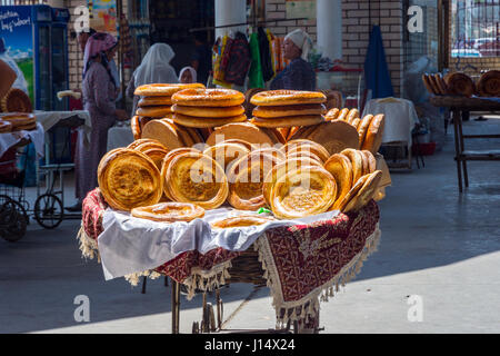 Traditional Uzbek bread called non or lepeshka in the trolley at the local market, Uzbekistan Stock Photo