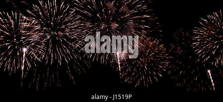 Festive fireworks in night sky. A single shot of the colorful fireworks in honor of the event. Firework multicolour fun and joyful. Different colors,  Stock Photo